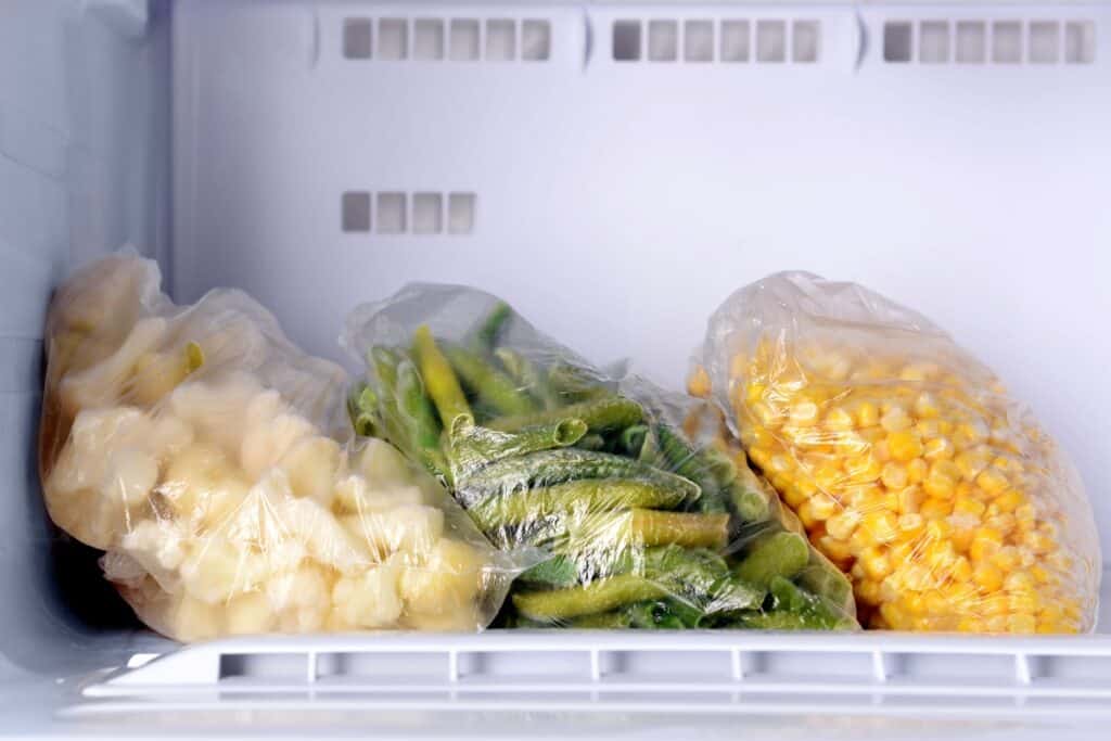 Frozen vegetables in bags in the freezer.