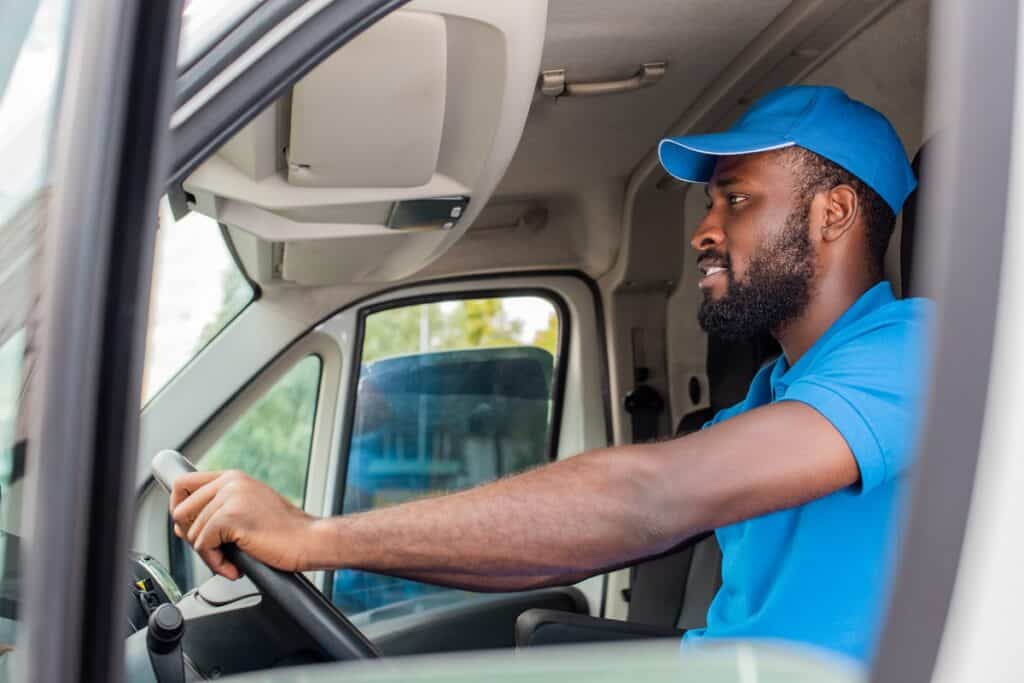 A man working as a delivery driver for a side hustle to earn money.