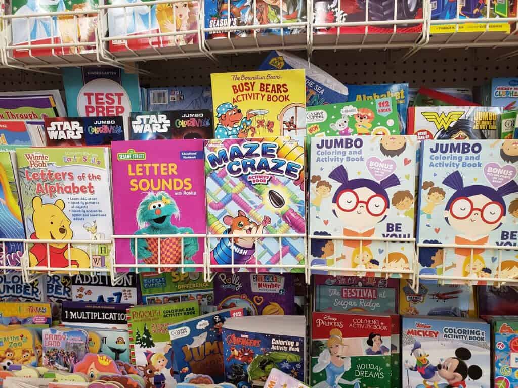 Coloring books and activity books on a shelf.