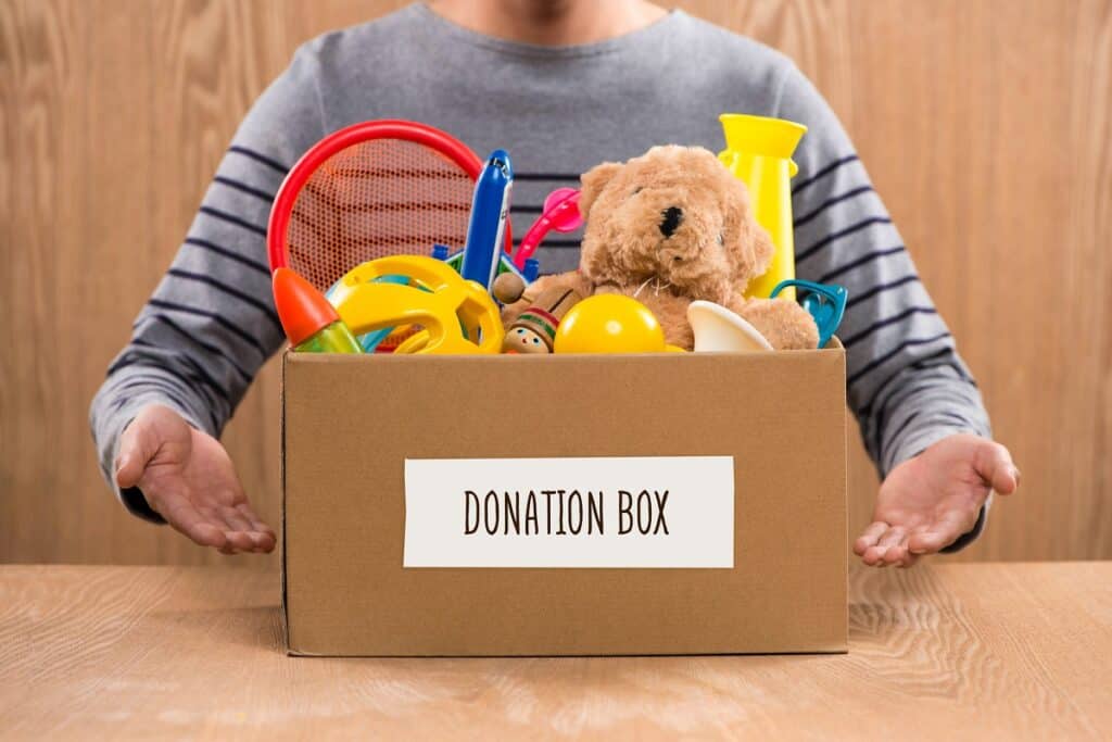 A child donating extra toys they no longer need.